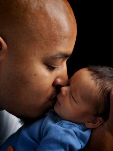 Father kissing baby